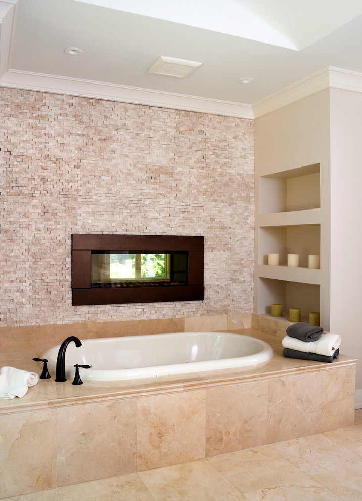 Design ideas for a large transitional master bathroom in DC Metro with a drop-in tub, raised-panel cabinets, white cabinets, a corner shower, a one-piece toilet, beige tile, limestone, beige walls, limestone floors, an undermount sink, granite benchtops, beige floor and a hinged shower door.