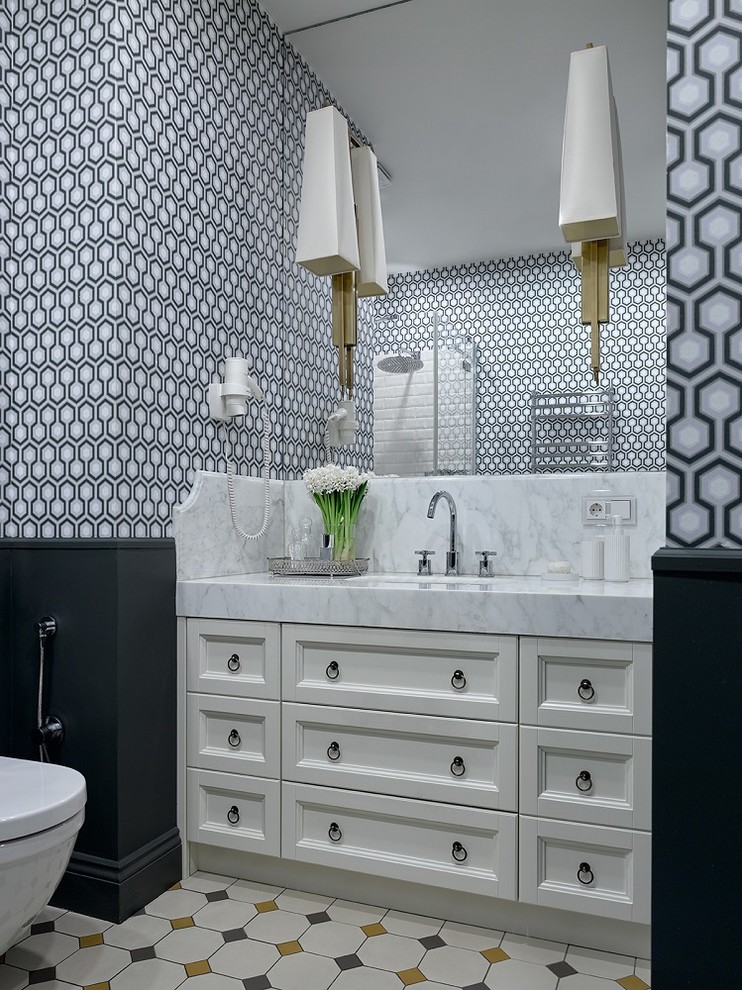 Design ideas for a transitional powder room in Moscow with recessed-panel cabinets, white cabinets, an undermount sink, multi-coloured floor and white benchtops.