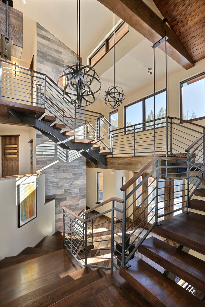This is an example of an expansive country wood staircase in Denver with open risers.