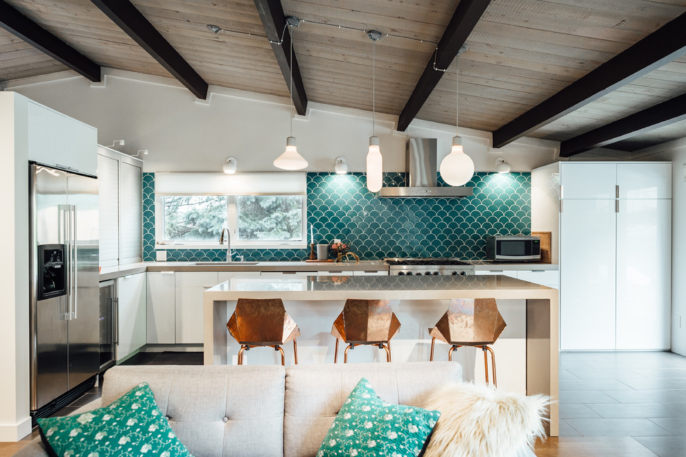 Inspiration for a mid-sized midcentury l-shaped open plan kitchen in Salt Lake City with an integrated sink, flat-panel cabinets, white cabinets, quartz benchtops, blue splashback, ceramic splashback, stainless steel appliances, medium hardwood floors, with island and brown floor.