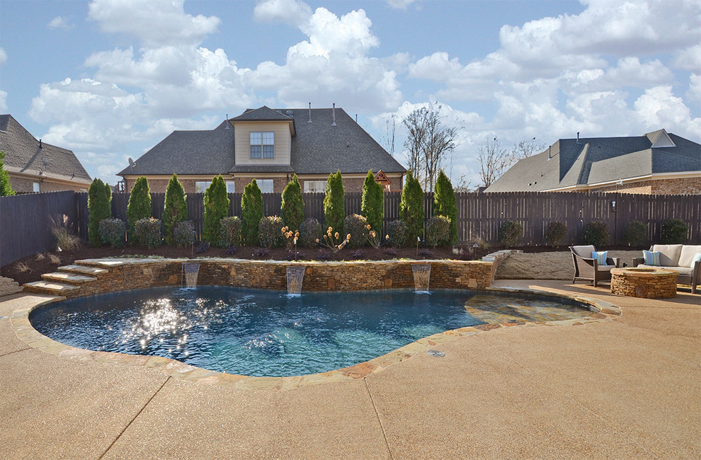 Example of a large island style backyard concrete and custom-shaped lap pool fountain design