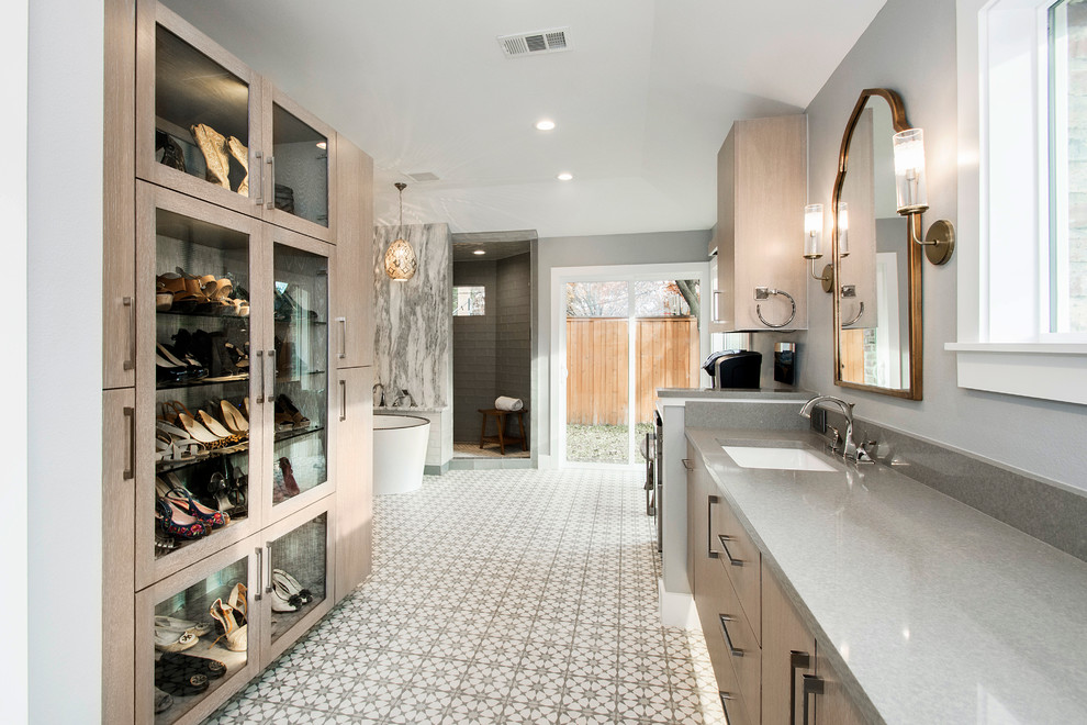 Photo of a large eclectic master bathroom in Dallas with flat-panel cabinets, light wood cabinets, a freestanding tub, an open shower, a two-piece toilet, gray tile, cement tile, grey walls, cement tiles, an undermount sink and quartzite benchtops.