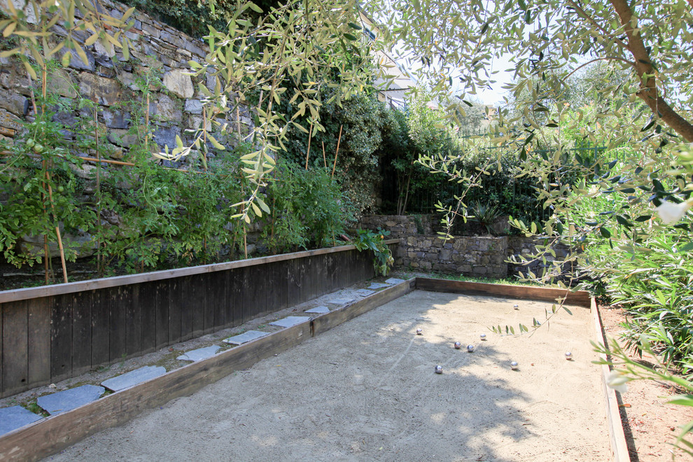 Design ideas for a mediterranean backyard partial sun outdoor sport court in Milan with a container garden and gravel.