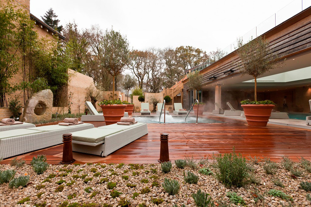 Inspiration for a contemporary side yard rectangular pool in Dorset with a hot tub and natural stone pavers.