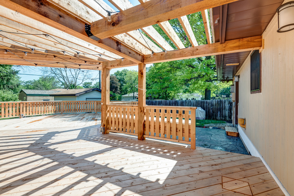 Inspiration for a large transitional backyard deck remodel in Chicago with a pergola