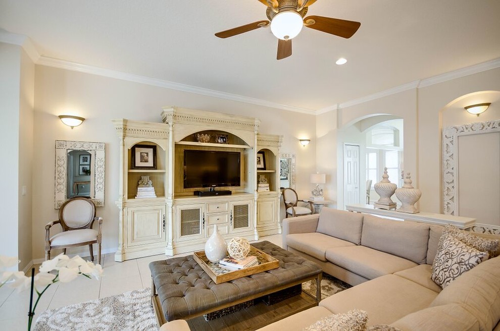 This is an example of a mid-sized transitional open concept family room in Tampa with beige walls, no fireplace, ceramic floors and beige floor.
