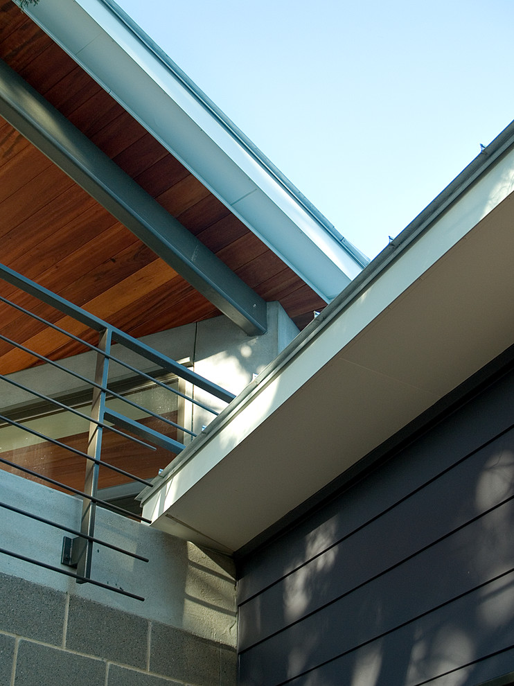 This is an example of a modern grey exterior in Austin with mixed siding.