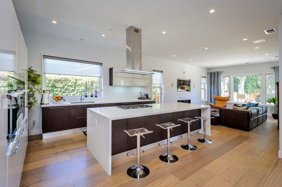 Photo of a contemporary open plan kitchen in San Francisco with flat-panel cabinets and dark wood cabinets.