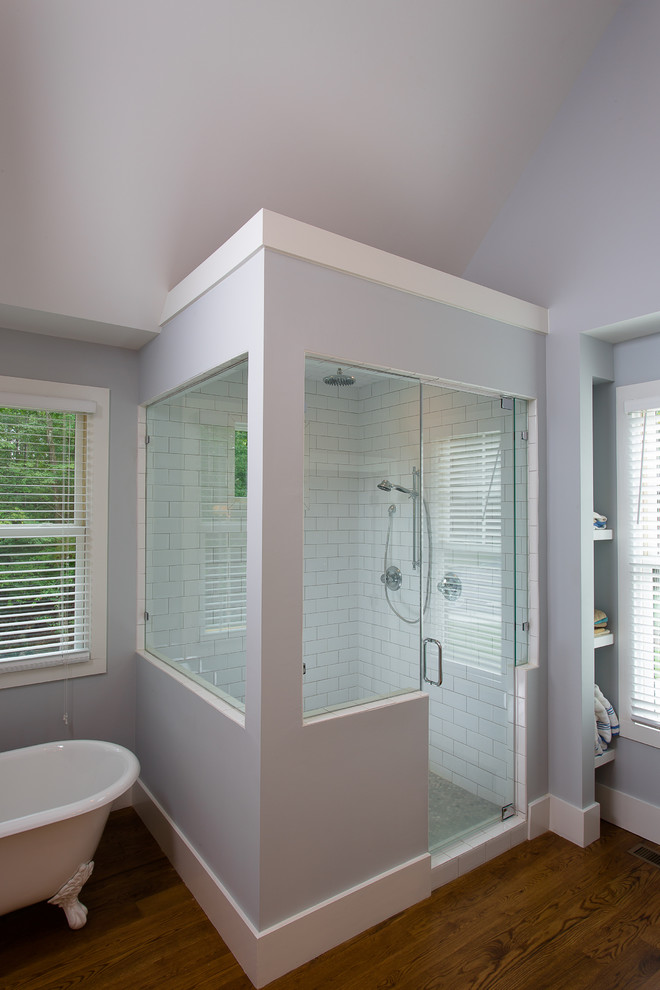 Mid-sized transitional master wet room bathroom in Atlanta with shaker cabinets, white cabinets, a freestanding tub, white tile, subway tile, blue walls, medium hardwood floors, an undermount sink, marble benchtops, beige floor and a hinged shower door.