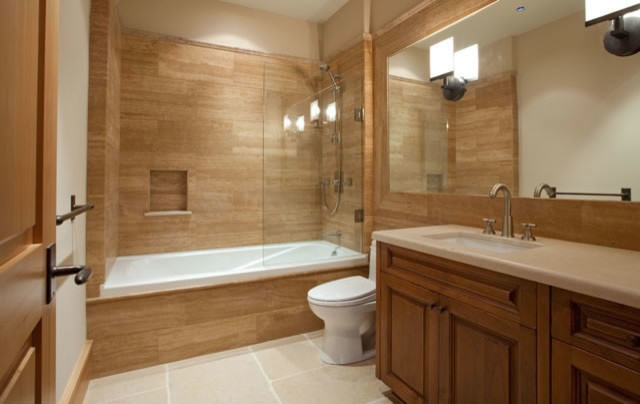 Stone tile bathroom photo in Miami with limestone countertops