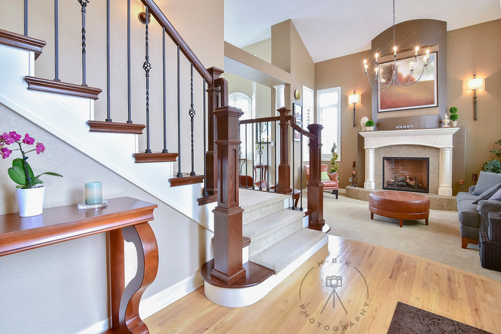 Mid-sized light wood floor and beige floor foyer photo with brown walls