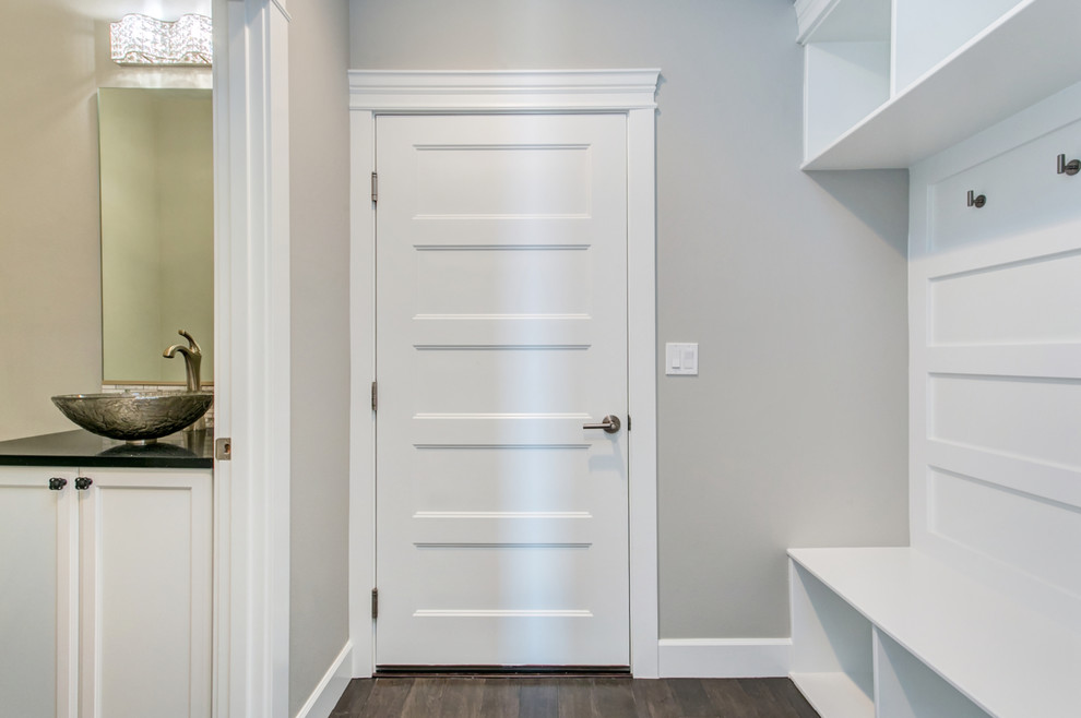 Example of a mid-sized transitional medium tone wood floor mudroom design in Seattle with gray walls