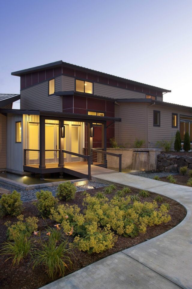 This is an example of a large traditional two-storey brown exterior in Seattle with a shed roof and metal siding.