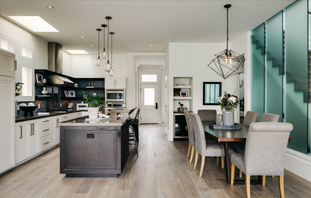 Photo of a large contemporary kitchen/dining combo in San Francisco with grey walls, light hardwood floors and beige floor.