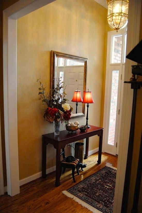 Photo of a mid-sized traditional foyer in Atlanta with yellow walls, medium hardwood floors and a single front door.