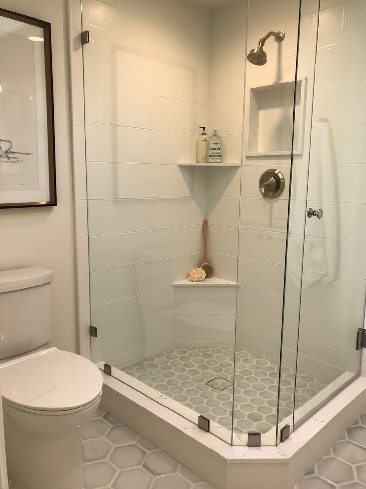 Photo of a small transitional master bathroom in Orange County with shaker cabinets, white cabinets, a corner shower, a one-piece toilet, white tile, porcelain tile, beige walls, ceramic floors, an undermount sink, engineered quartz benchtops, blue floor, a hinged shower door and white benchtops.