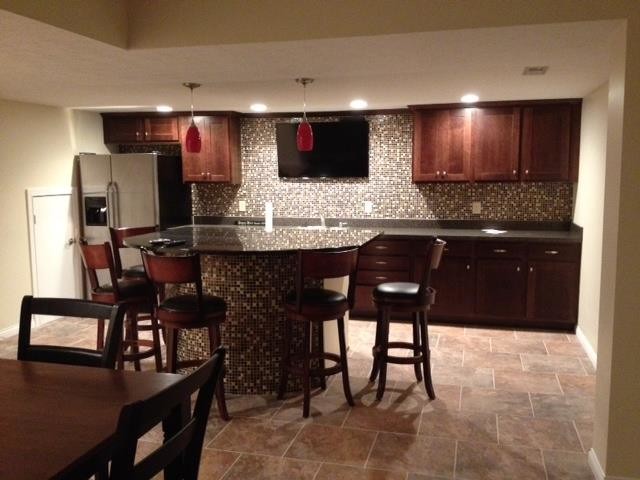 Enclosed kitchen - large single-wall ceramic tile enclosed kitchen idea in Indianapolis with a drop-in sink, dark wood cabinets, granite countertops, multicolored backsplash, mosaic tile backsplash, stainless steel appliances and an island