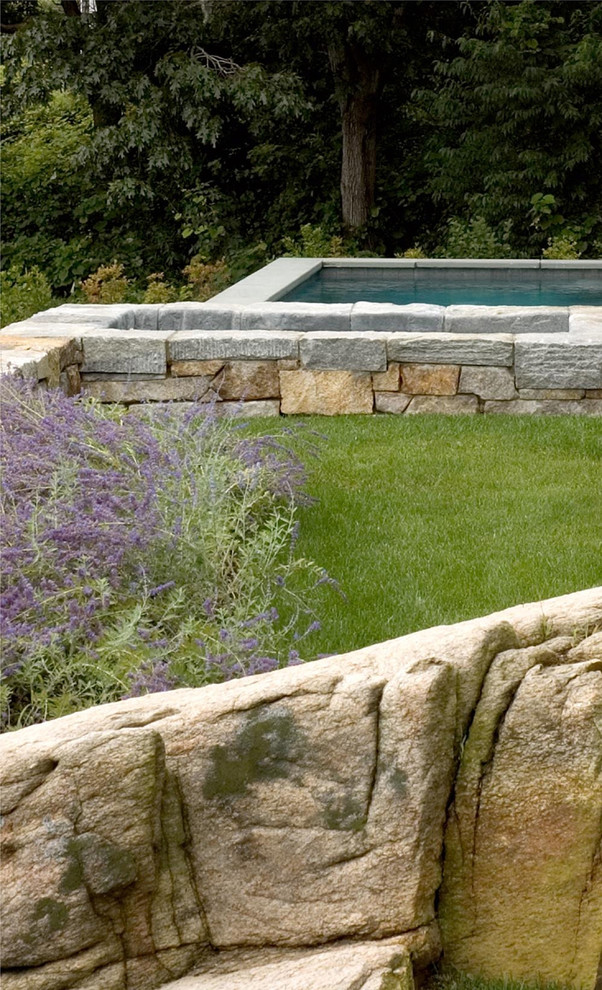 Inspiration for a large traditional backyard partial sun outdoor sport court for summer in Boston with natural stone pavers and a water feature.
