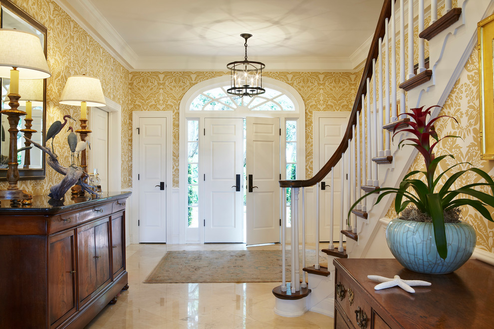 This is an example of a mid-sized beach style foyer in Miami with beige walls, a double front door, a white front door and black floor.