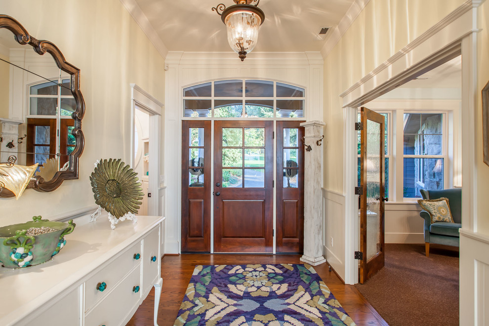 Photo of a large traditional front door in Portland with yellow walls, medium hardwood floors, a single front door and a medium wood front door.