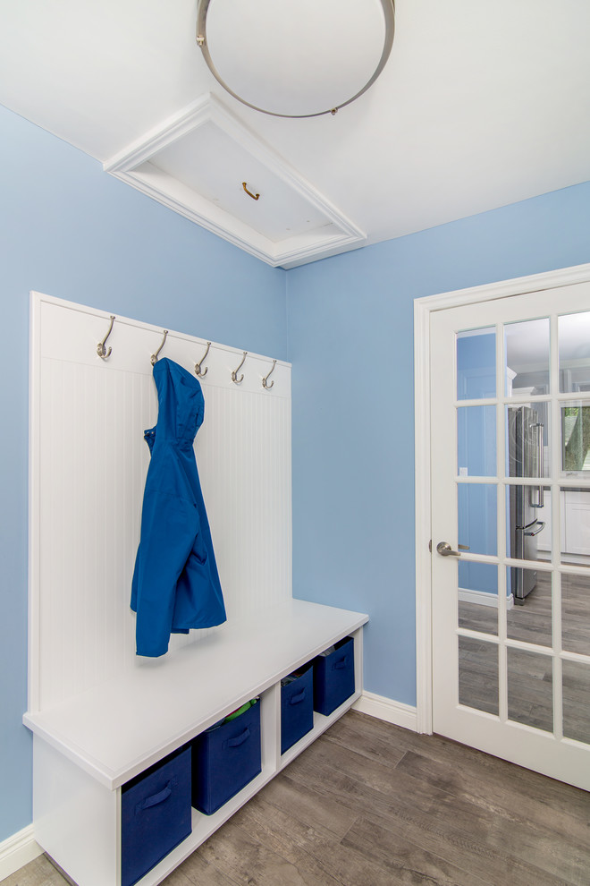 Example of a mid-sized transitional light wood floor mudroom design with blue walls and a glass front door