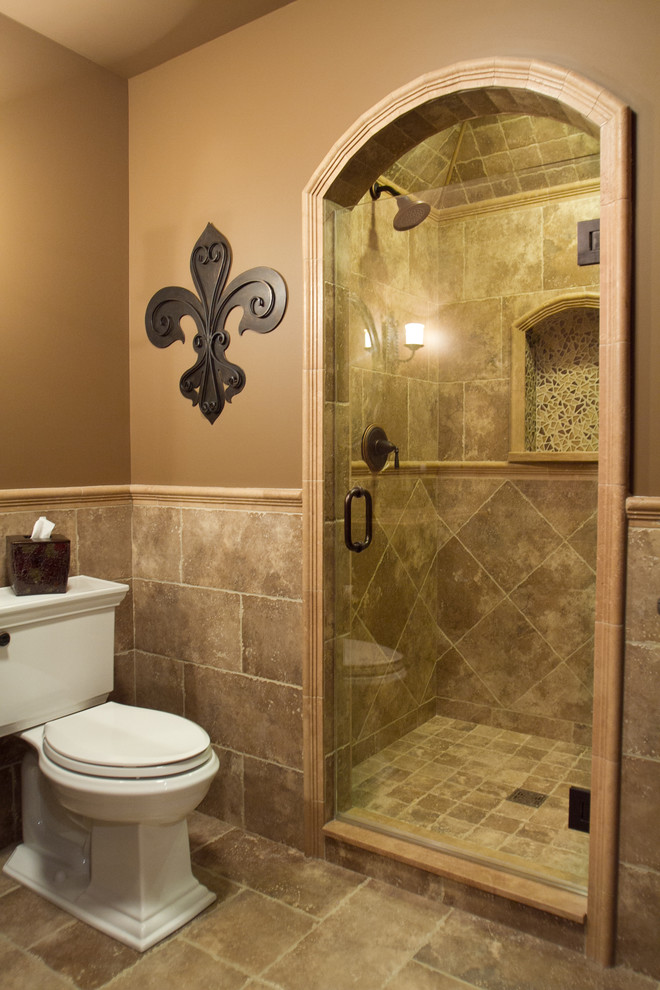 Design ideas for a mid-sized traditional 3/4 bathroom in Chicago with a pedestal sink, raised-panel cabinets, dark wood cabinets, granite benchtops, an alcove shower, a two-piece toilet, beige tile, porcelain tile, beige walls and porcelain floors.