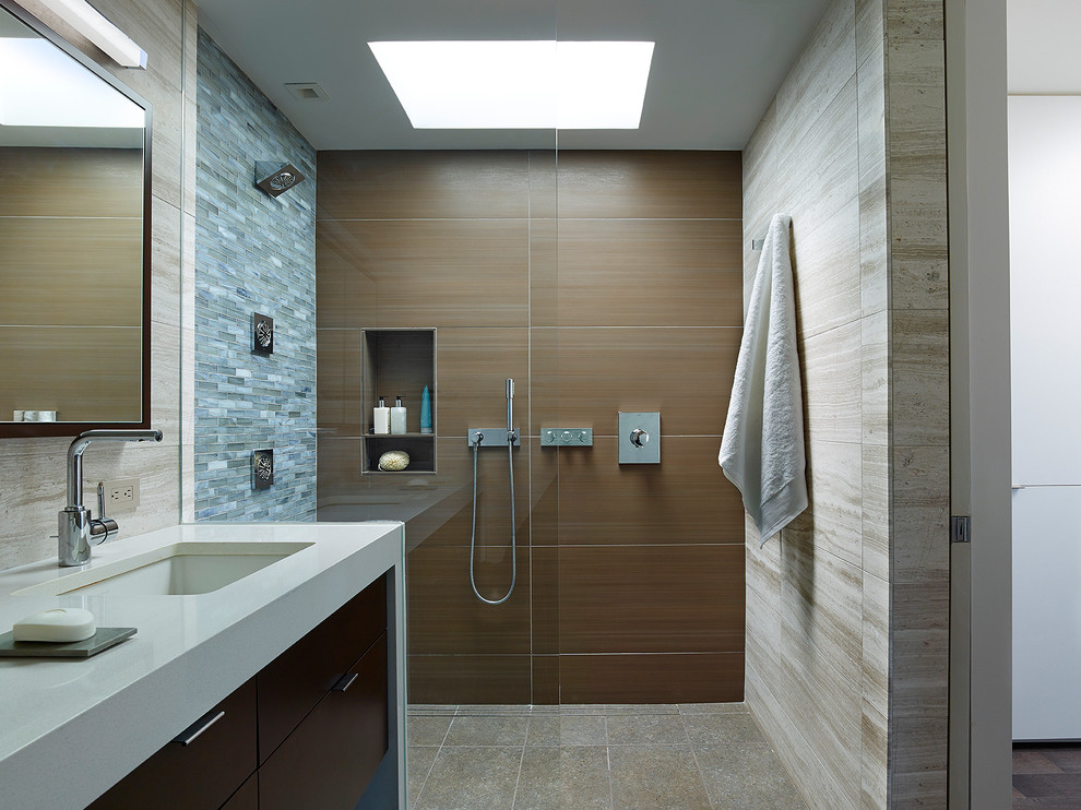 This is an example of a mid-sized contemporary bathroom in Philadelphia with flat-panel cabinets, dark wood cabinets, brown tile, an undermount sink, engineered quartz benchtops, a curbless shower, porcelain tile, porcelain floors, beige walls, grey floor and an open shower.