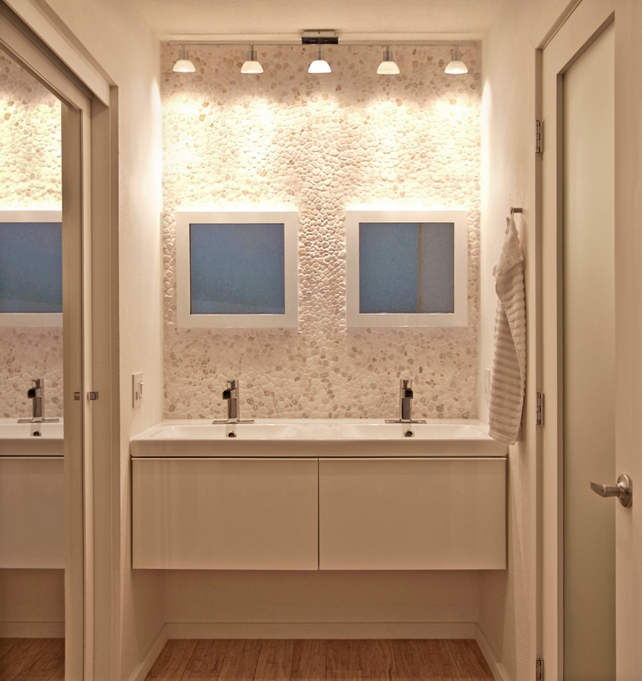 Contemporary bathroom in San Diego with pebble tile.