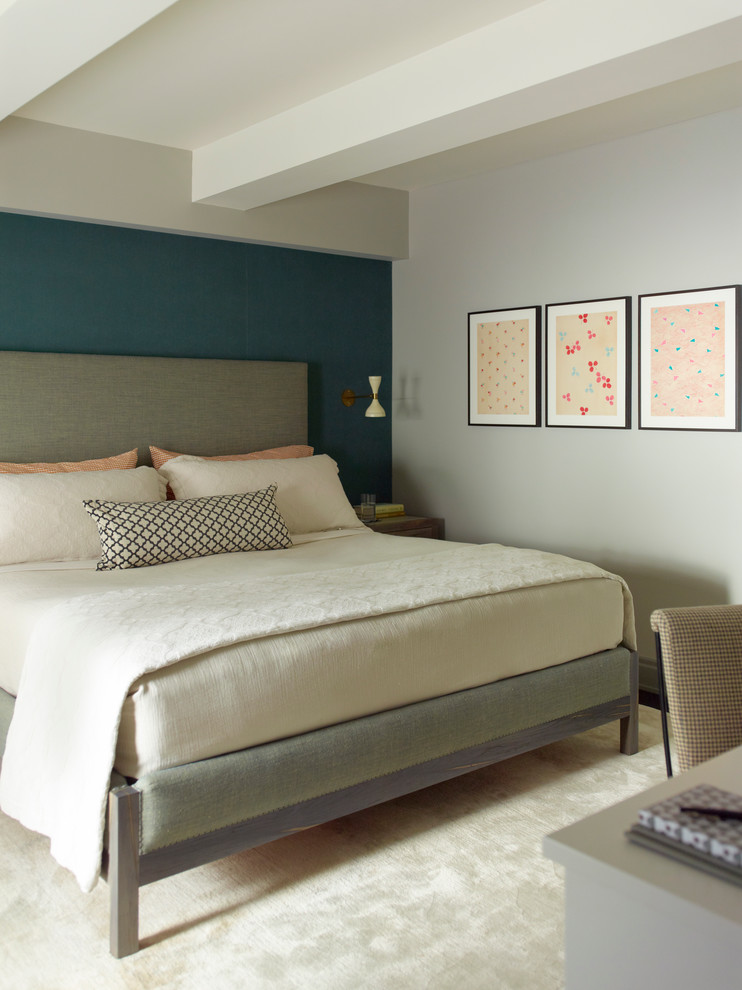 Transitional master bedroom in New York with blue walls.
