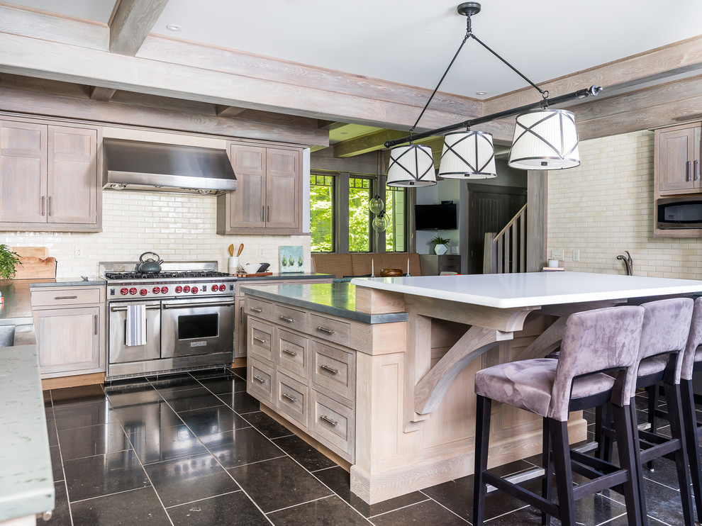 Photo of a large country l-shaped eat-in kitchen in Boston with a double-bowl sink, beaded inset cabinets, beige cabinets, concrete benchtops, beige splashback, ceramic splashback, stainless steel appliances, marble floors, with island, black floor and grey benchtop.