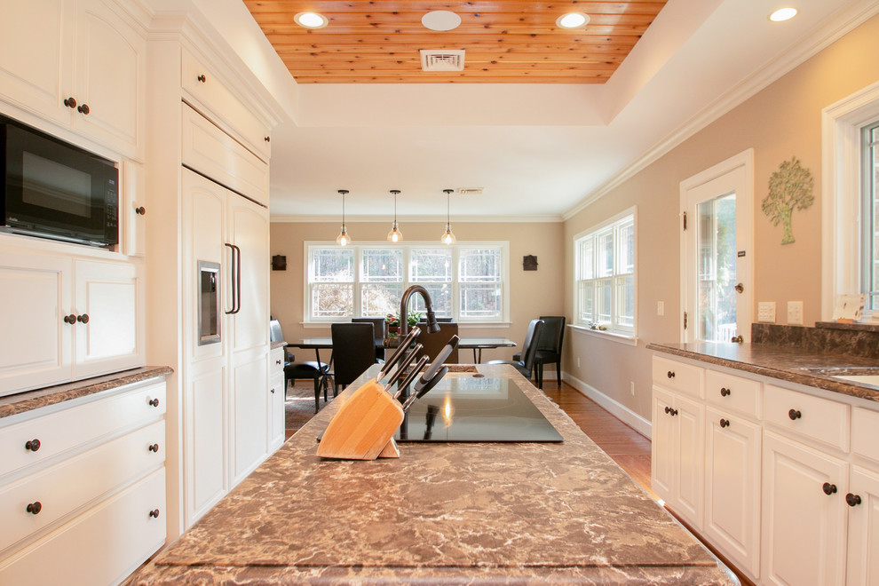 Inspiration for a large modern galley light wood floor and brown floor eat-in kitchen remodel with raised-panel cabinets, white cabinets, brown backsplash, an island, brown countertops, a single-bowl sink, quartzite countertops and paneled appliances