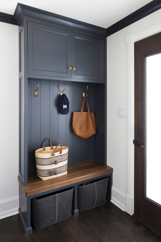 Medium sized traditional boot room in Milwaukee with white walls, dark hardwood flooring, a single front door, a dark wood front door, brown floors and tongue and groove walls.