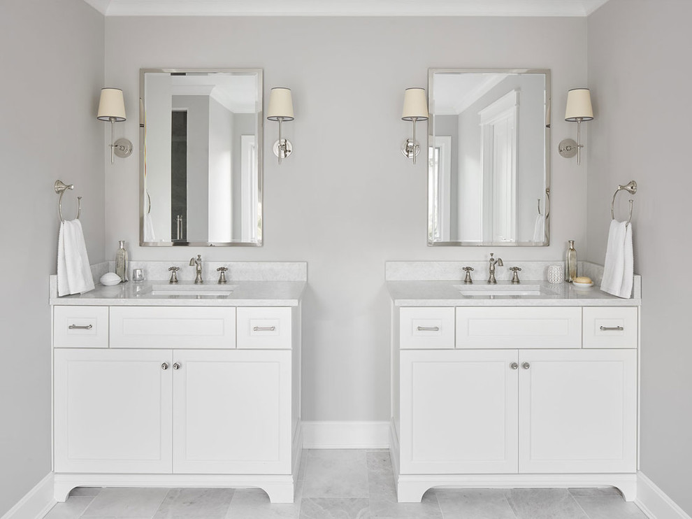 This is an example of a mid-sized transitional 3/4 bathroom in Chicago with recessed-panel cabinets, white cabinets, an alcove shower, grey walls, marble floors, an undermount sink, marble benchtops, grey floor, a hinged shower door, a freestanding tub, gray tile, white tile and marble.