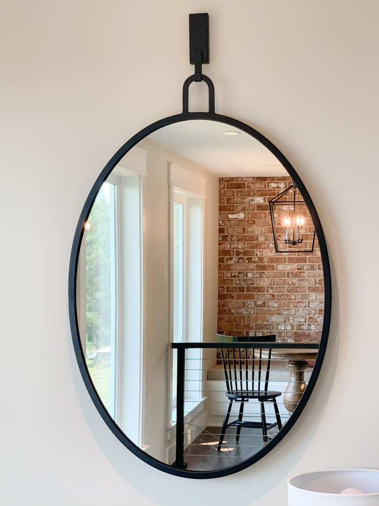 Mid-sized country entry hall in Portland with white walls, dark hardwood floors and brick walls.