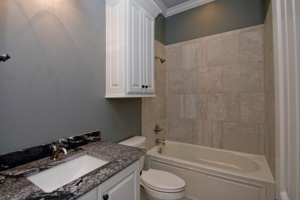 Design ideas for a large transitional master bathroom in Little Rock with raised-panel cabinets, white cabinets, a shower/bathtub combo, grey walls, an undermount sink, granite benchtops, an alcove tub, gray tile, porcelain tile and porcelain floors.