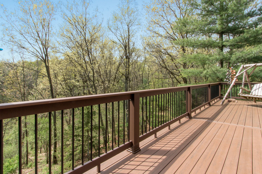 Example of a huge mountain style backyard deck design in Milwaukee with no cover