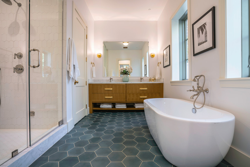 This is an example of an expansive contemporary master bathroom in Los Angeles with flat-panel cabinets, medium wood cabinets, a freestanding tub, an alcove shower, white tile, ceramic tile, white walls, cement tiles, an undermount sink, marble benchtops, multi-coloured floor and a hinged shower door.