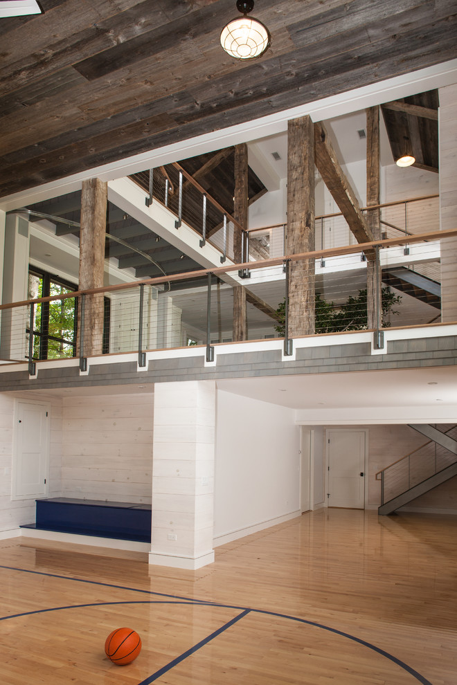 Indoor basketball/tennis/multi-game court - huge transitional light wood floor indoor basketball/tennis/multi-game court idea in Bridgeport with white walls