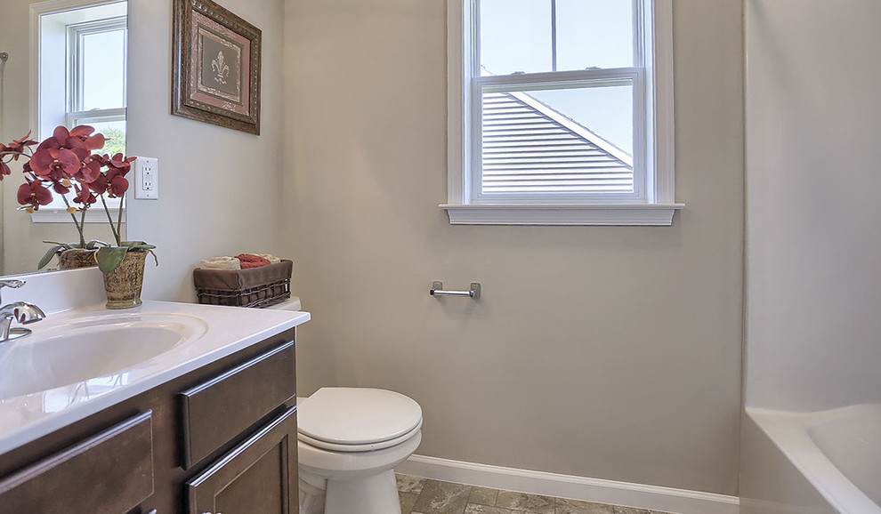 Photo of a large traditional master bathroom in Other with a shower/bathtub combo, a two-piece toilet, grey walls, ceramic floors, an integrated sink, multi-coloured floor, a shower curtain and white benchtops.