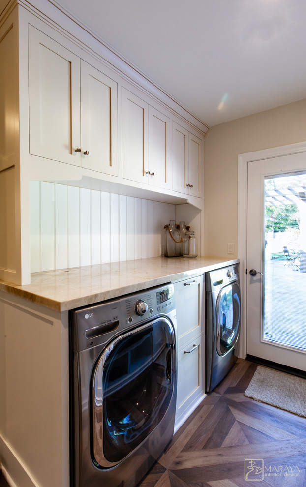 Inspiration for a mid-sized arts and crafts galley dedicated laundry room in Los Angeles with a drop-in sink, recessed-panel cabinets, white cabinets, granite benchtops, white walls, porcelain floors and a side-by-side washer and dryer.