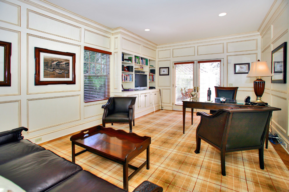 Traditional home office in Denver with white walls, medium hardwood floors and a freestanding desk.
