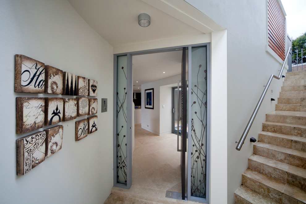 Photo of an entryway in Sydney with white walls, travertine floors, a pivot front door and a metal front door.