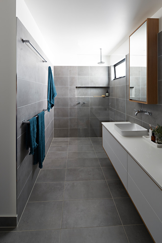 Design ideas for a mid-sized modern master bathroom in Melbourne with white cabinets, an open shower, gray tile, grey walls, a vessel sink, grey floor, an open shower, white benchtops, furniture-like cabinets and engineered quartz benchtops.