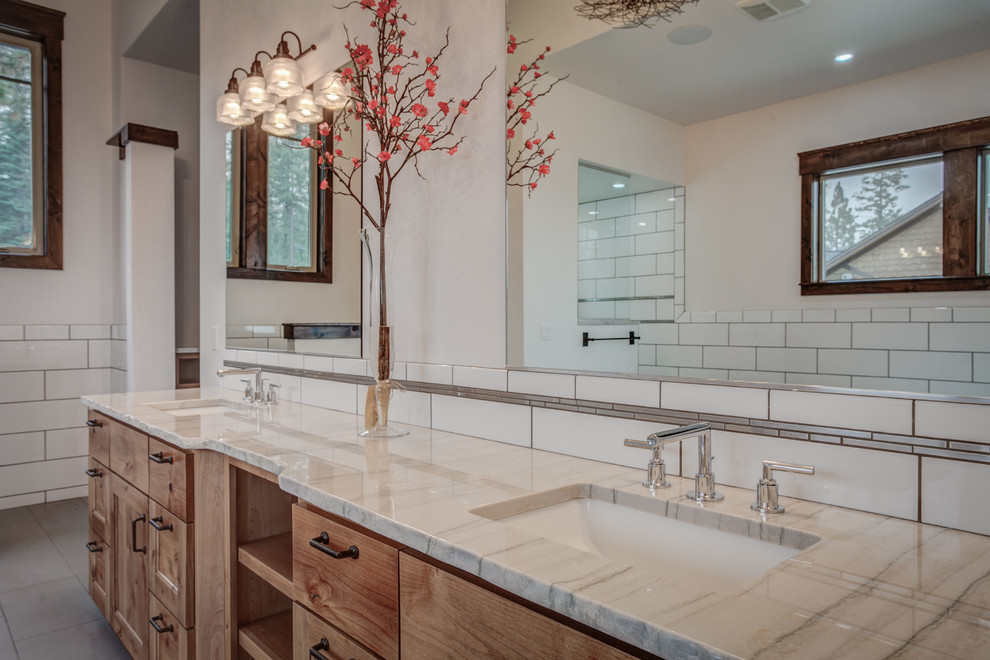 Inspiration for a large country master bathroom in Seattle with a drop-in sink, shaker cabinets, medium wood cabinets, granite benchtops, white tile, subway tile, white walls and ceramic floors.