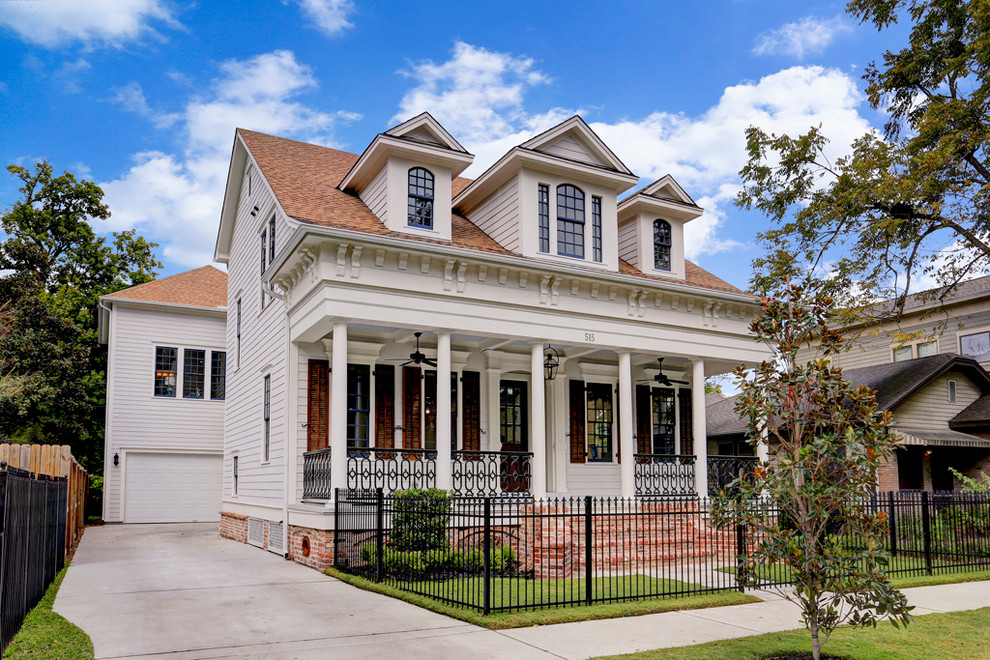 This is an example of a traditional two-storey white exterior in Houston with a gable roof.