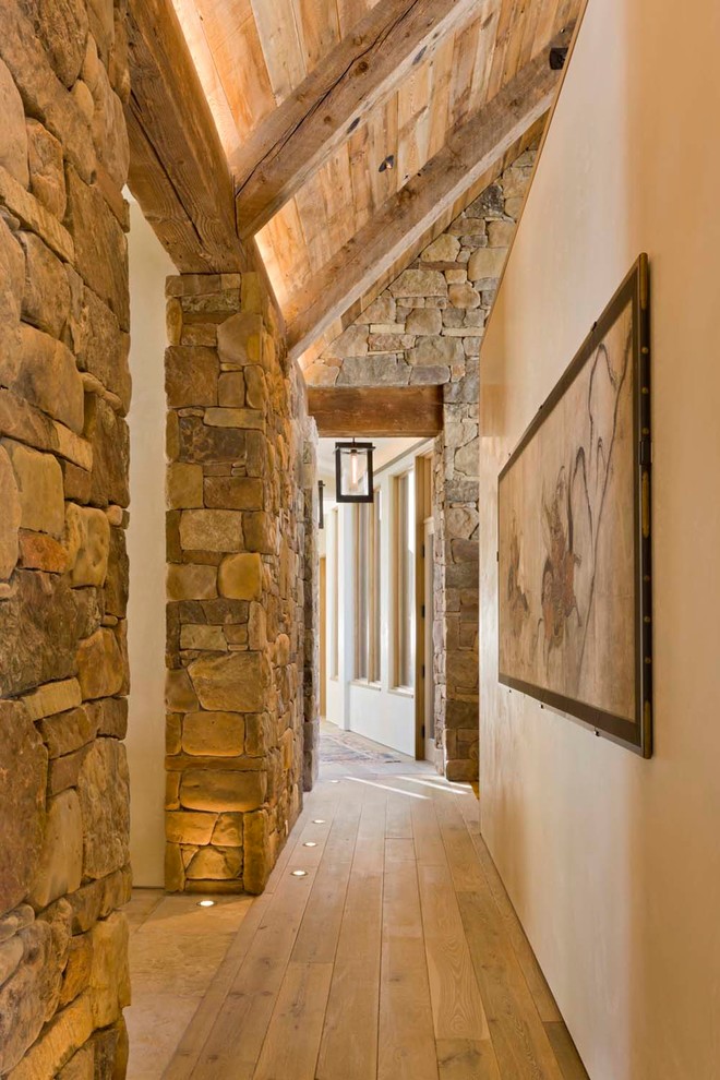 Inspiration for a country hallway in Denver with beige walls, beige floor and light hardwood floors.