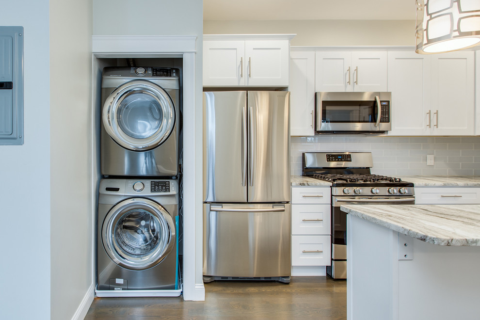Inspiration for a mid-sized transitional l-shaped dark wood floor and brown floor enclosed kitchen remodel in Boston with an undermount sink, shaker cabinets, white cabinets, marble countertops, gray backsplash, subway tile backsplash, stainless steel appliances, an island and white countertops