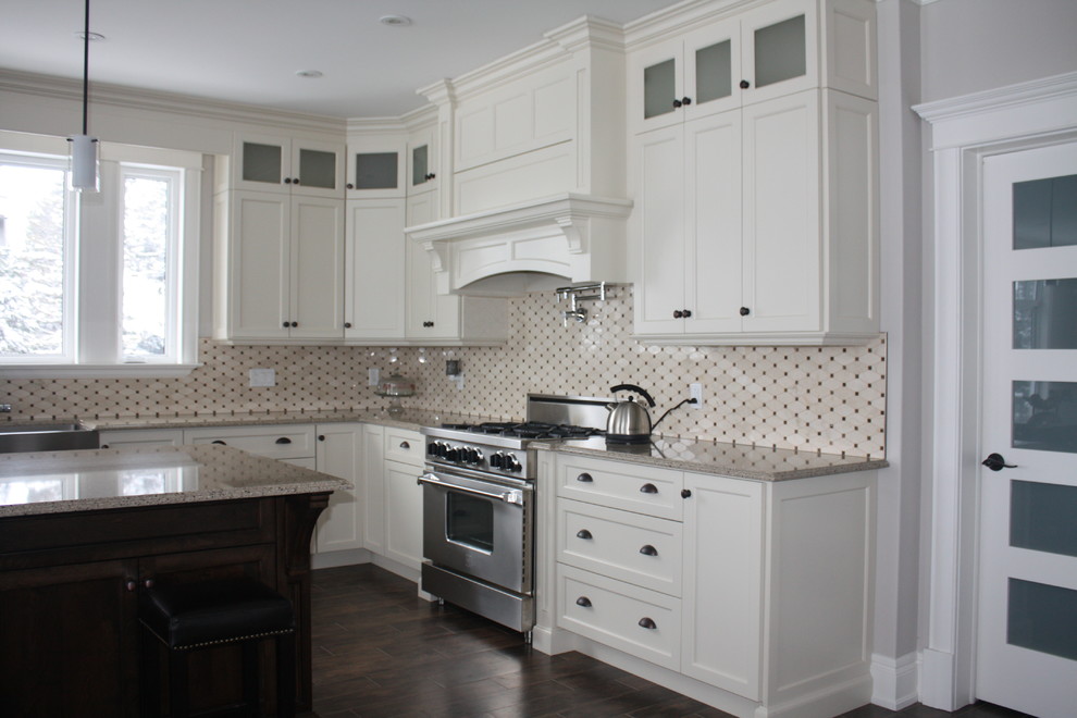 Inspiration for a large timeless l-shaped medium tone wood floor eat-in kitchen remodel with an island, recessed-panel cabinets, yellow cabinets, quartz countertops, black backsplash, cement tile backsplash, stainless steel appliances and a farmhouse sink