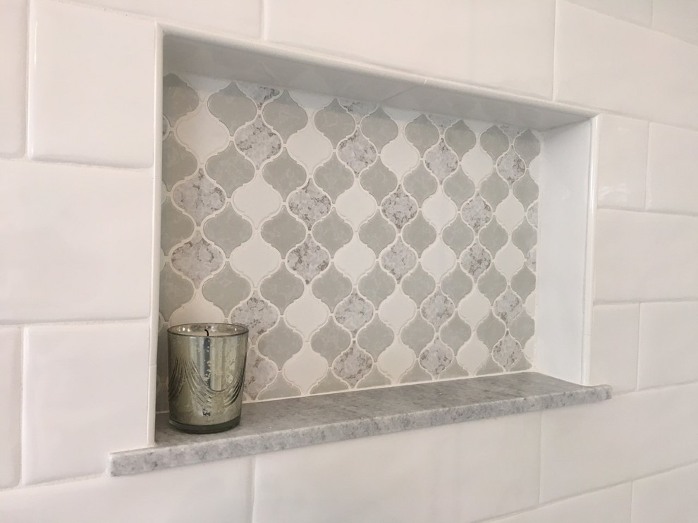 Mid-sized transitional master white tile and ceramic tile porcelain tile and gray floor corner shower photo with recessed-panel cabinets, white cabinets, an undermount tub, a two-piece toilet, gray walls, an undermount sink, marble countertops and a hinged shower door
