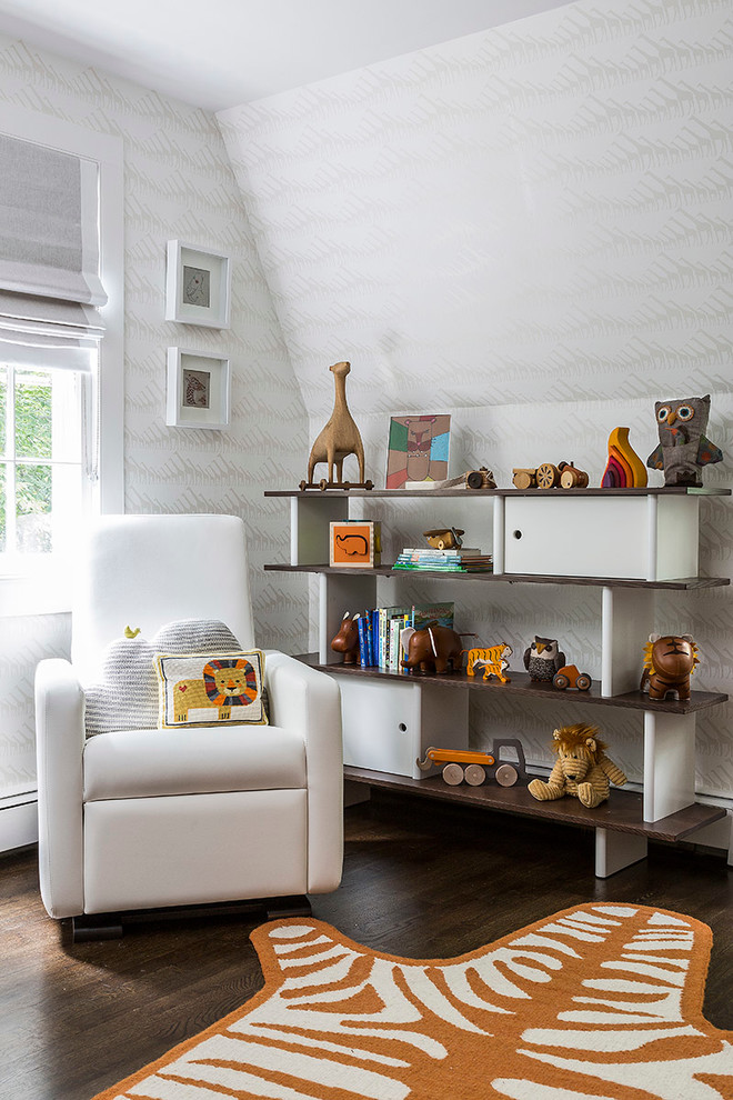 This is an example of a transitional gender-neutral nursery in New York with grey walls and dark hardwood floors.